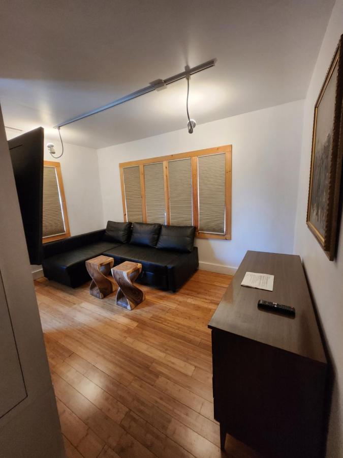 Separate apartment den with sofa and television